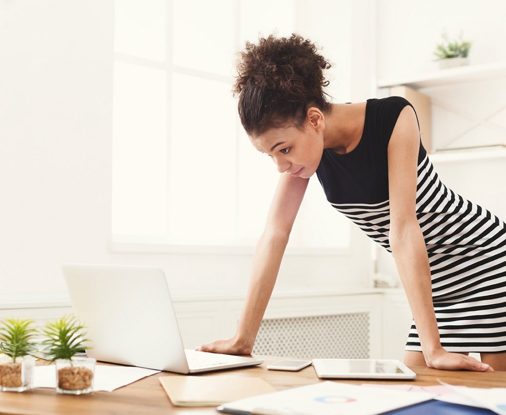 business-woman-working-on-laptop-at-office-PRFJKQJ