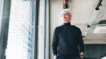 mature-businessman-with-gray-hair-in-the-office-PF9SFHW