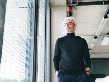 mature-businessman-with-gray-hair-in-the-office-PF9SFHW