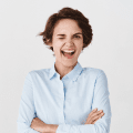 happy-confident-woman-feeling-motivated-winking-smiling-standing-office-clothing-white-wall 1