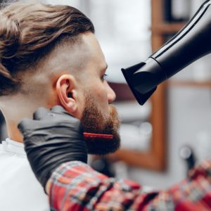 Man with a beard. Hairdresser with a client.