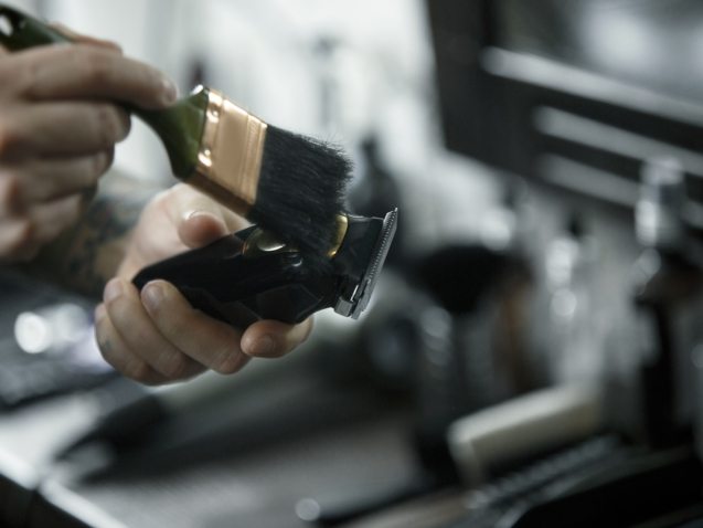 The male hands and tools for cutting beard at barbershop. Vintage tools of barber shop