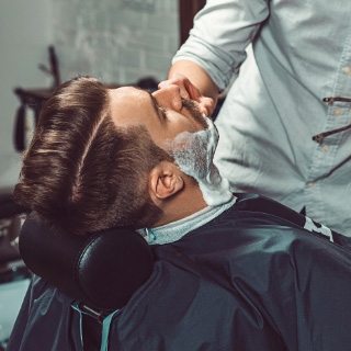 hipster-client-visiting-barber-shop-P349LDW