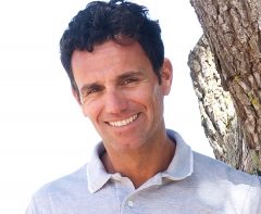 smiling-middle-aged-man-standing-outdoors-PTRPK6H