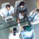 diverse-medical-team-working-together-at-table-in-8CASYHB