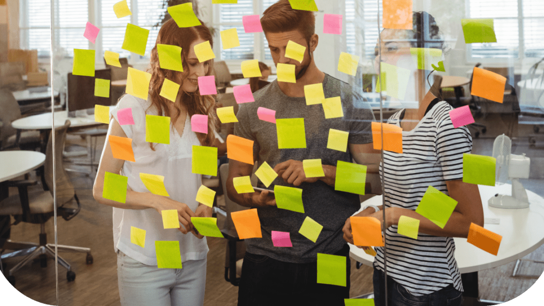business-executives-standing-near-glass-with-sticky-notes-di 1 (1)