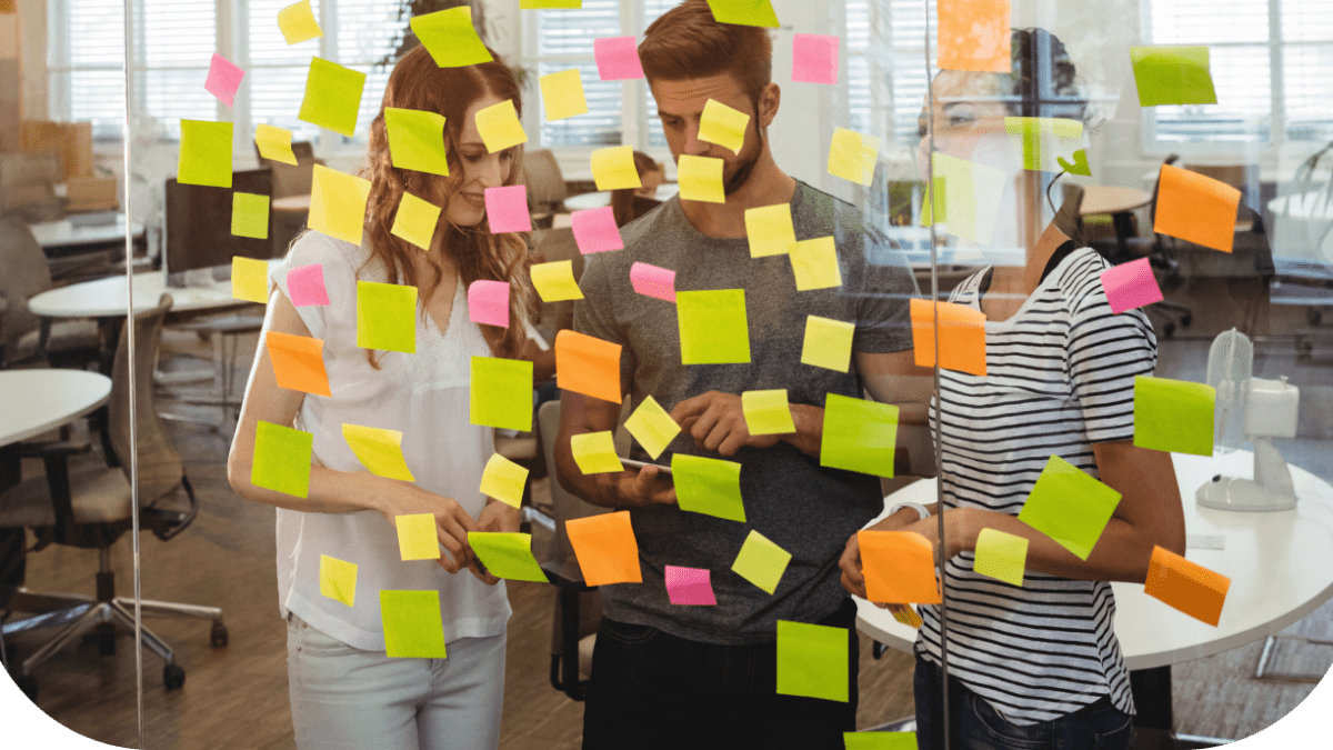 business-executives-standing-near-glass-with-sticky-notes-di 1 (1)
