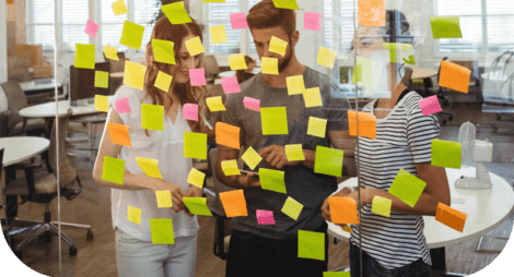 business-executives-standing-near-glass-with-sticky-notes-di 1 (1)