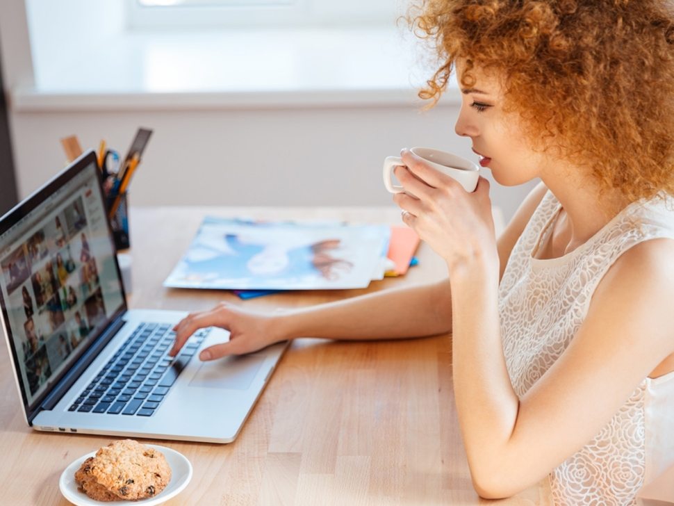 woman-photographer-drinking-coffee-and-working-PJNBP6U@2x