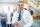 cheerful-mature-doctor-with-tablet-in-hospital-UW72G9C