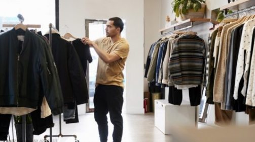 cropped-young-hispanic-man-looking-at-clothes-on-a-rail-PYSF-1-1.jpg