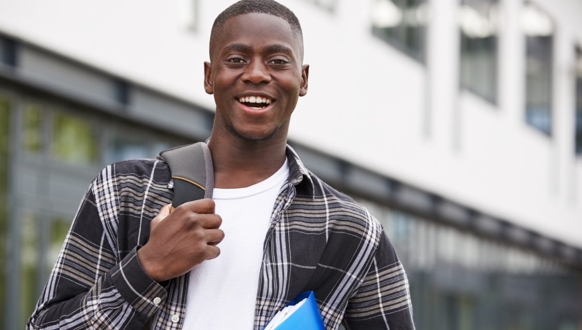 portrait-of-male-student-standing-outside-college-P9XQ4UM