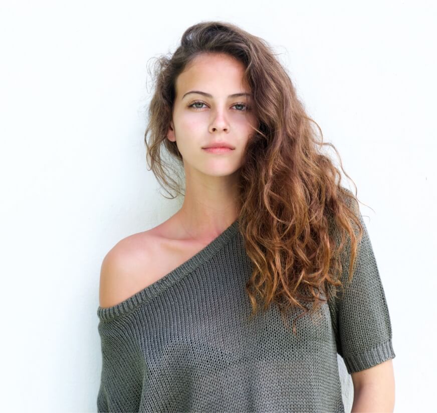 attractive-confident-woman-standing-against-white-PX2A5SQ