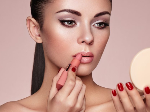 beautiful-woman-paints-lips-with-lipstick-PMB6YWP-1
