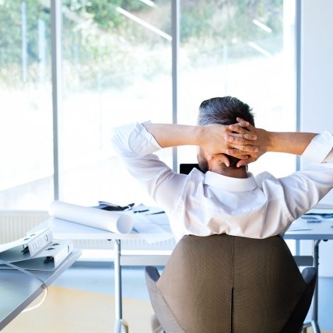 Businessman at the desk in his office resting.