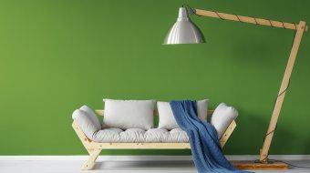 Cozy sofa in scandinavian style living room with a giant lamp and a blue blanket