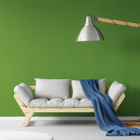 Cozy sofa in scandinavian style living room with a giant lamp and a blue blanket