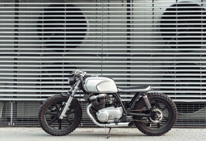 motorcycle-standing-in-dark-building-in-rays-of-P6PVJNM