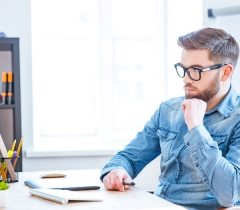 Thoughtful designer using graphic tablet and computer
