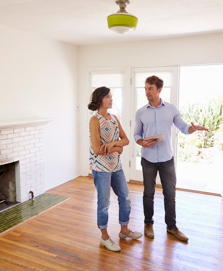 male-realtor-showing-female-client-around-house-PXLCYLL-784x951