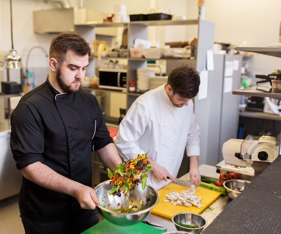 chef-and-cook-cooking-food-at-restaurant-kitchen-P5WACEM