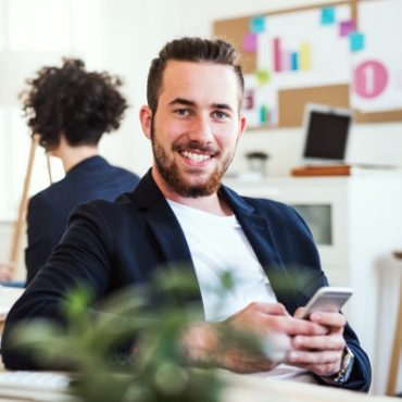 a-portrait-of-young-businessman-with-smartphone-A2GKEC4
