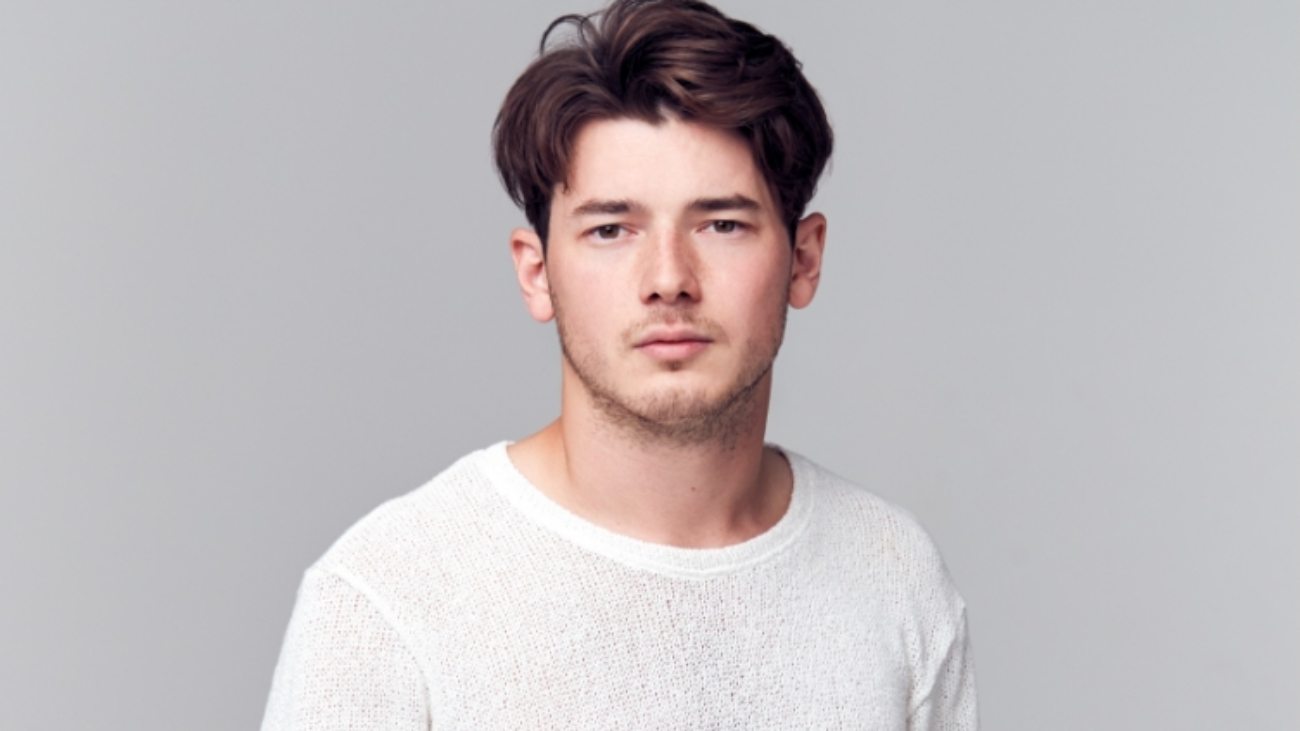 studio-portrait-of-young-man-with-serious-8YSPPQM