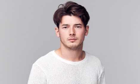 studio-portrait-of-young-man-with-serious-8YSPPQM