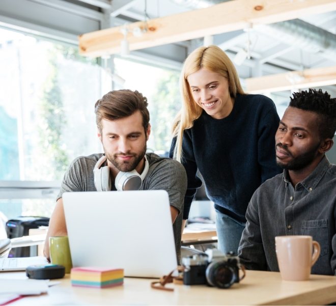 happy-colleagues-sitting-in-office-coworking-PHYA6TG