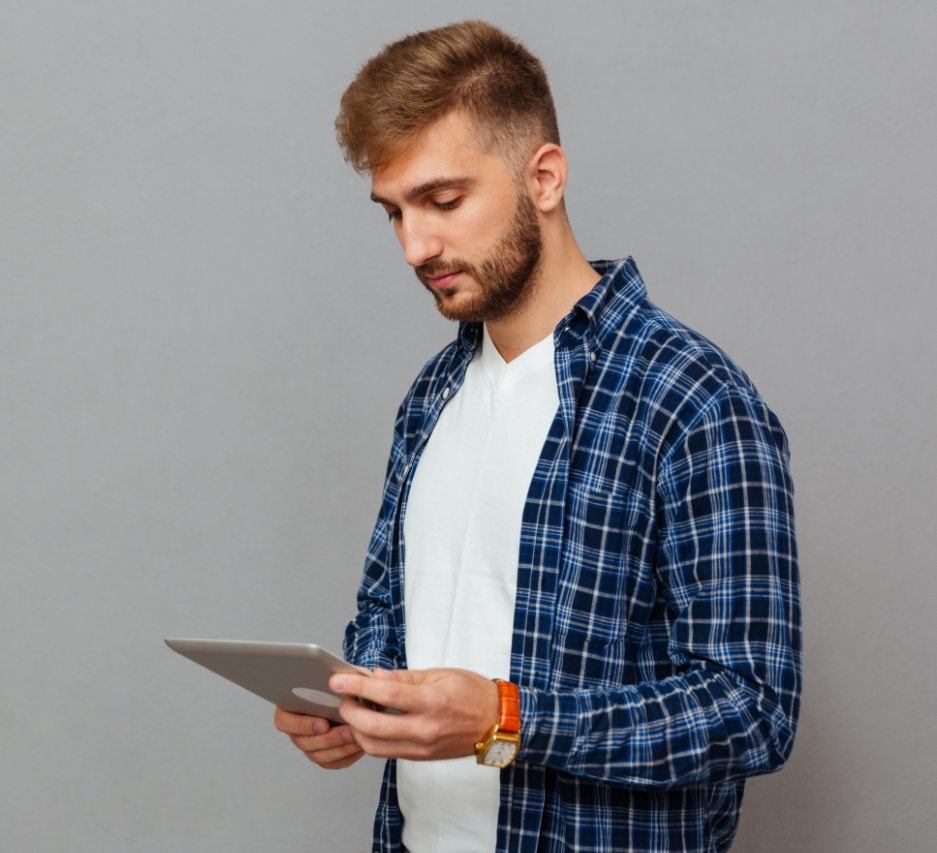 portrait-of-a-man-using-tablet-computer-PCDLD3R