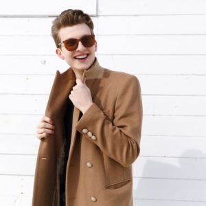 portrait-of-smiling-attractive-young-man-in-coat-PVQXBUM