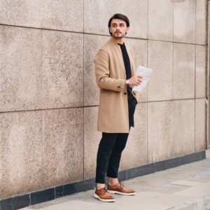 young-confident-man-in-beige-coat-with-reading-RKC4WBR (2)