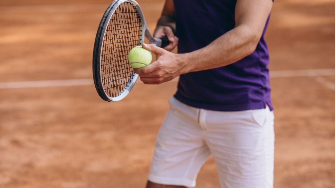 young-man-tennis-player-court-tennis-racket-close-up(1)