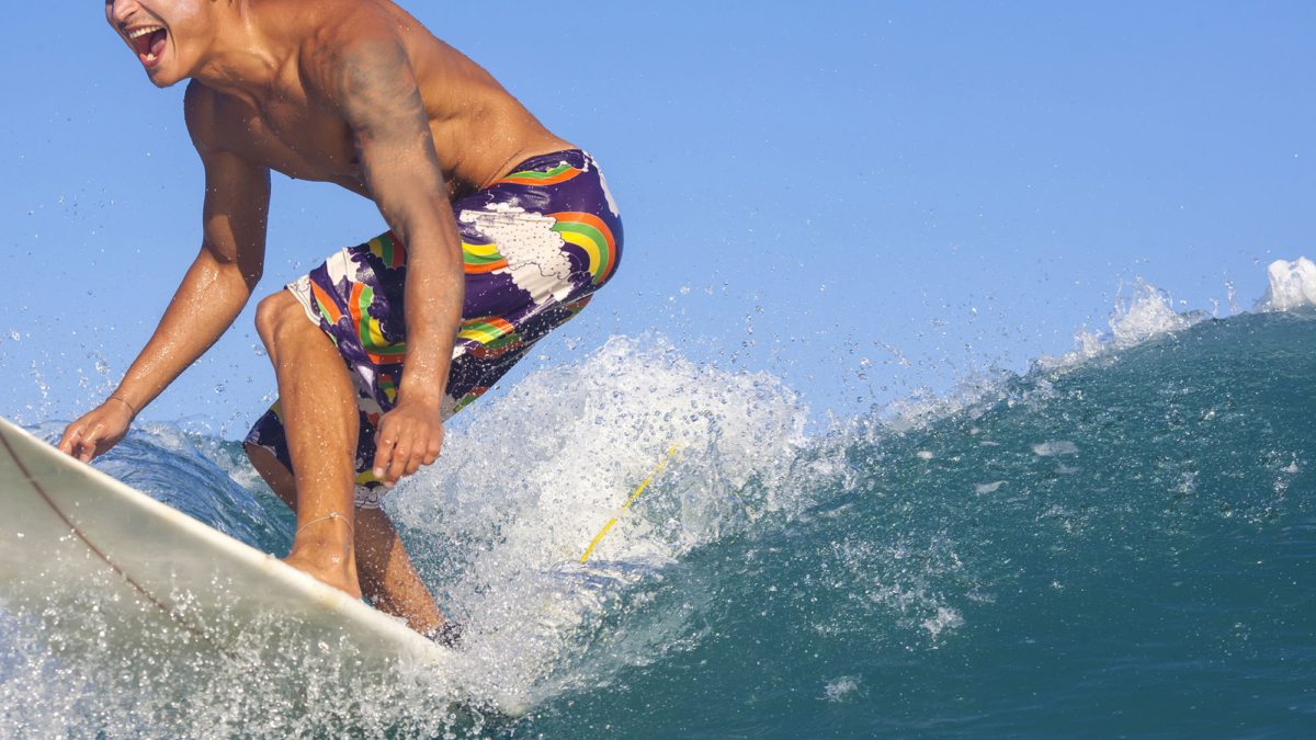 surfing-excited-man-catching-wave