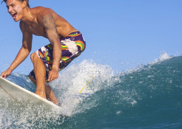 surfing-excited-man-catching-wave