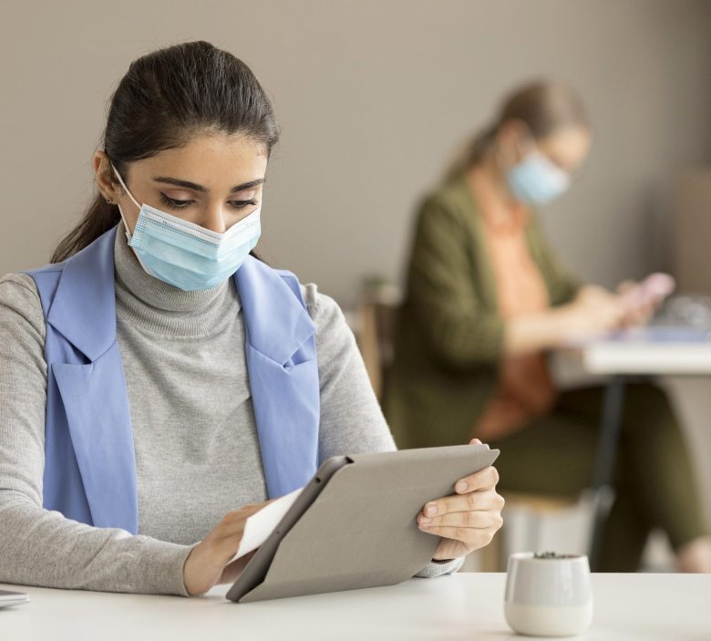 employee-disinfecting-electronic-device